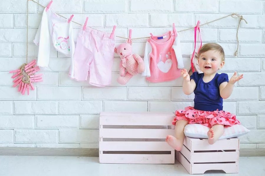 A baby child is wearing the clothes which is used malory laundry detergent to laundry