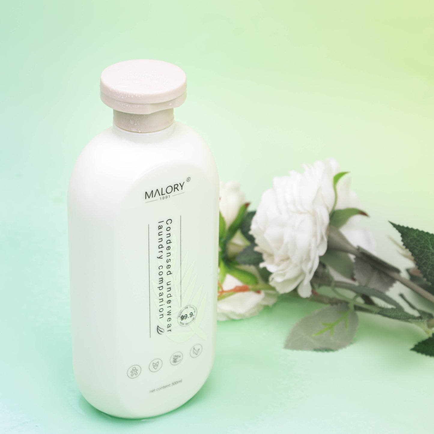 Display of MALORY Concentrated Laundry Detergent with Flowers Behind the Bottle